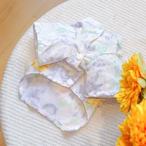 Detail of floral pet kimono with lavender cherry blossom pattern and gold waist accent