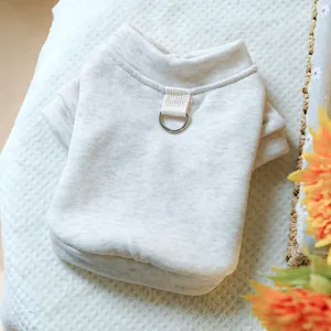 Detail of oatmeal dog sweater featuring reinforced back strap and metal D-ring for leash