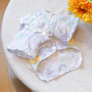 Detailed view of floral pet kimono with white buttons and golden ribbon accents