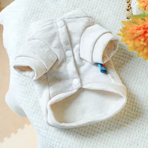 Detail of soft cream pet sweatshirt showing snap buttons and inner fleece texture