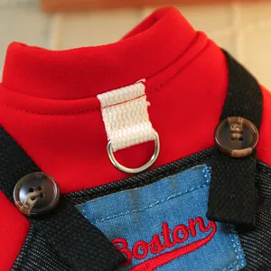 Detail of red knit pet jacket with metal D-ring and Boston embroidery patch