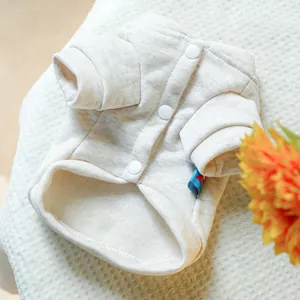Detail of pet fleece hoodie featuring snap buttons and warm cream-colored knit texture