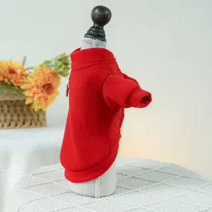 Detail of red pet sweatshirt with built-in metal D-ring for leash attachment