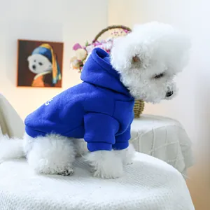 Detail view of a royal blue pet hoodie with warm fleece lining on a small dog