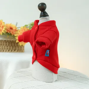 Detail of red button-up pet hoodie with ribbed cuffs on a small model stand