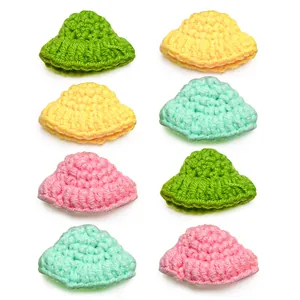 Close-up of colorful handmade crochet mini hat hair clips for pet cats and dogs