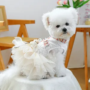 Elegant white lace pet dress with floral pearls for small dogs in a home setting