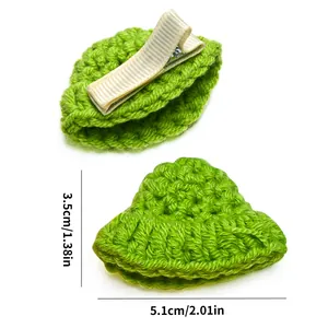 Detail view of handmade green knitted pet hair clips with metal duckbill clips and dimensions