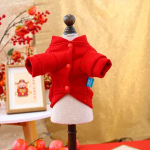 Close-up of red festive pet sweater with warm fleece fabric and button details