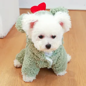 Detail of green plush dog jumpsuit featuring cute furry ears and a red heart accent