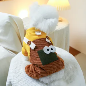 Detail of dog winter jumpsuit with yellow hoodie, brown corduroy pants and a metal D-ring