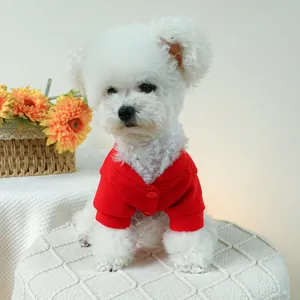 Detail of red pet cardigan hoodie with snap buttons on a white small dog