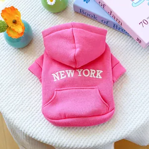 Detail of pink dog hoodie showing white New York embroidery and front pocket