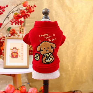 Detail of red pet New Year vest with Happy New Year text and cute dog pattern