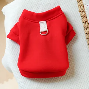 Detail of red pet hoodie featuring a metal D-ring for leash attachment and soft fabric
