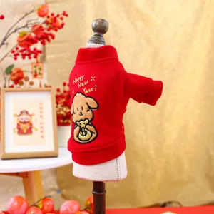 Close-up of red festive pet sweater with embroidered cartoon dog and Happy New Year text