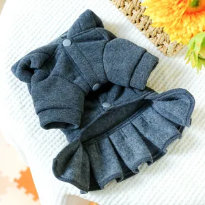 Detail of dark grey pet dress featuring knit fabric, pleated hem and button closure