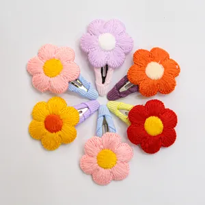 Set of seven embroidered flower pet hair clips in vibrant colors and floral patterns