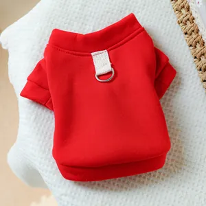 Detail of red pet hoodie featuring a metal D-ring for leash attachment on cotton fabric