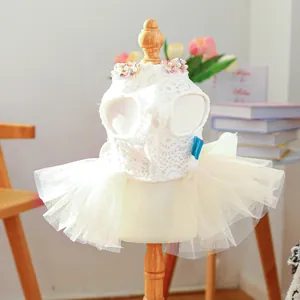 Close-up of white pet princess dress with delicate lace floral and pearl neckline detail