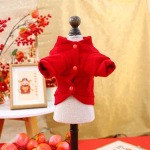 Close-up of red festive pet fleece jacket with plush texture and decorative buttons