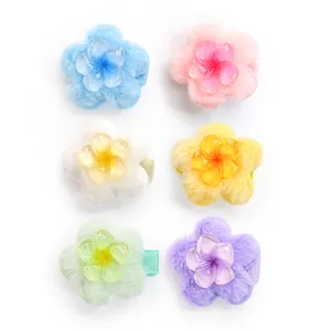 Detail of colorful plush flower pet hair clips in a six-piece assorted candy color set