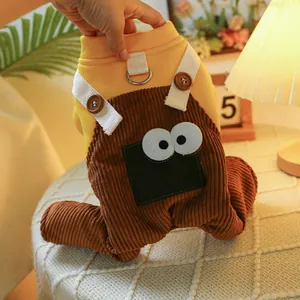 Close-up of pet jumpsuit detail showing monster eye patch and metal D-ring attachment