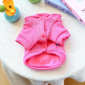 Close-up of pink pet hoodie showing soft fleece lining and three snap buttons