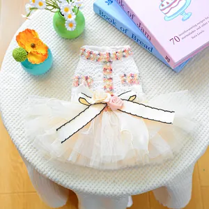 Detailed view of white pet lace dress with pearls, ribbon bow and 3D floral accents