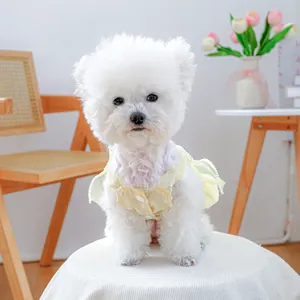 Detail of yellow polka dot pet dress with ruffled edges and pearl beads for small dogs