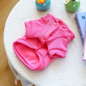 Detail of pink fleece dog sweatshirt with snap buttons and ribbed cuffs for small pets