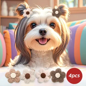 Close-up of four soft plush flower hair clips for dogs in earthy neutral colors
