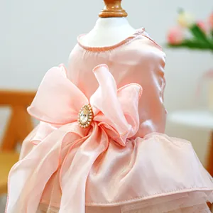 Detail of pink pet dress with large organza bow, pearl and rhinestone centerpiece