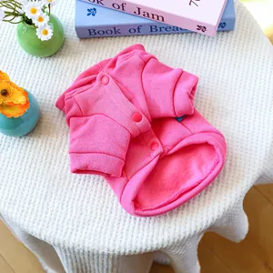 Close-up of pink fleece-lined pet cardigan with button closure for small dogs