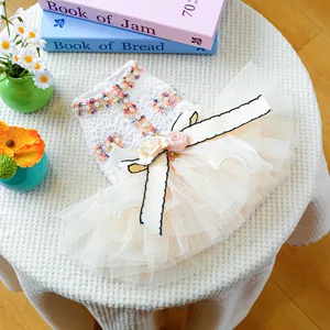 Detail of elegant pet dress with lace embroidery, tulle layers and 3D floral bow decoration