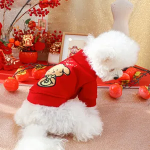 Close-up of festive red pet sweater with Happy New Year embroidery and soft fleece texture