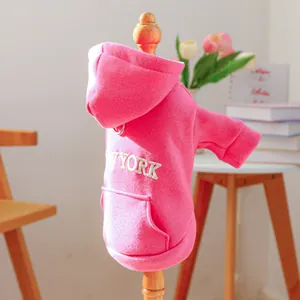 Detail of pink dog hoodie featuring New York embroidery and metal D-ring for leash