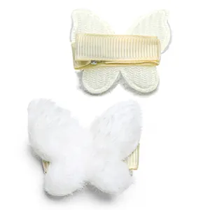 Detail of plush butterfly hair clips showing soft white fur and anti-slip metal duckbill clip