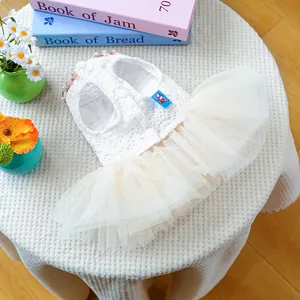 Detail of white pet dress with floral lace bodice and colorful pearl neckline decor