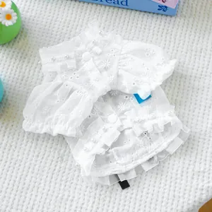 Close-up of white floral lace pet shirt with pearl charms and elegant ruffle details
