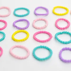 Macro shot of macaron colored seamless spiral hair ties in a flat lay grid arrangement