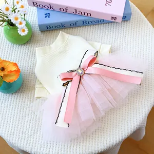 Detailed view of dog dress featuring multi-layer pink tulle and rhinestone bow ornament