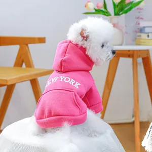 Close-up of pink dog hoodie with New York letter print on soft cotton fabric