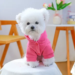 Detail of rose pink fleece dog hoodie with button closure for small dogs on a Bichon