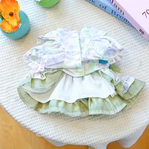 Detailed view of floral pet dress with lace edges and green layered ruffled skirt