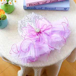 Detail of sequined purple dog dress with layered tulle skirt and rhinestone bow decoration