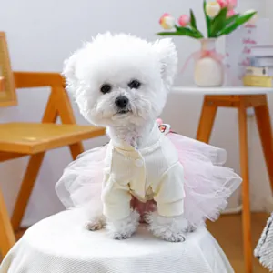 Detail of pet dress with cream knit cardigan and pink tulle tutu on a white dog