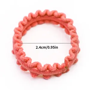 Detail showing 2.4cm diameter of coral pink wavy elastic hair band for pets