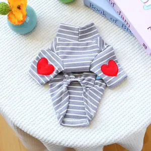 Detail of grey striped dog shirt with ribbed texture and two red heart patches