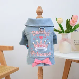 Cute denim pet jacket with pink bow and Daddy's Princess crown embroidery on a wooden stand